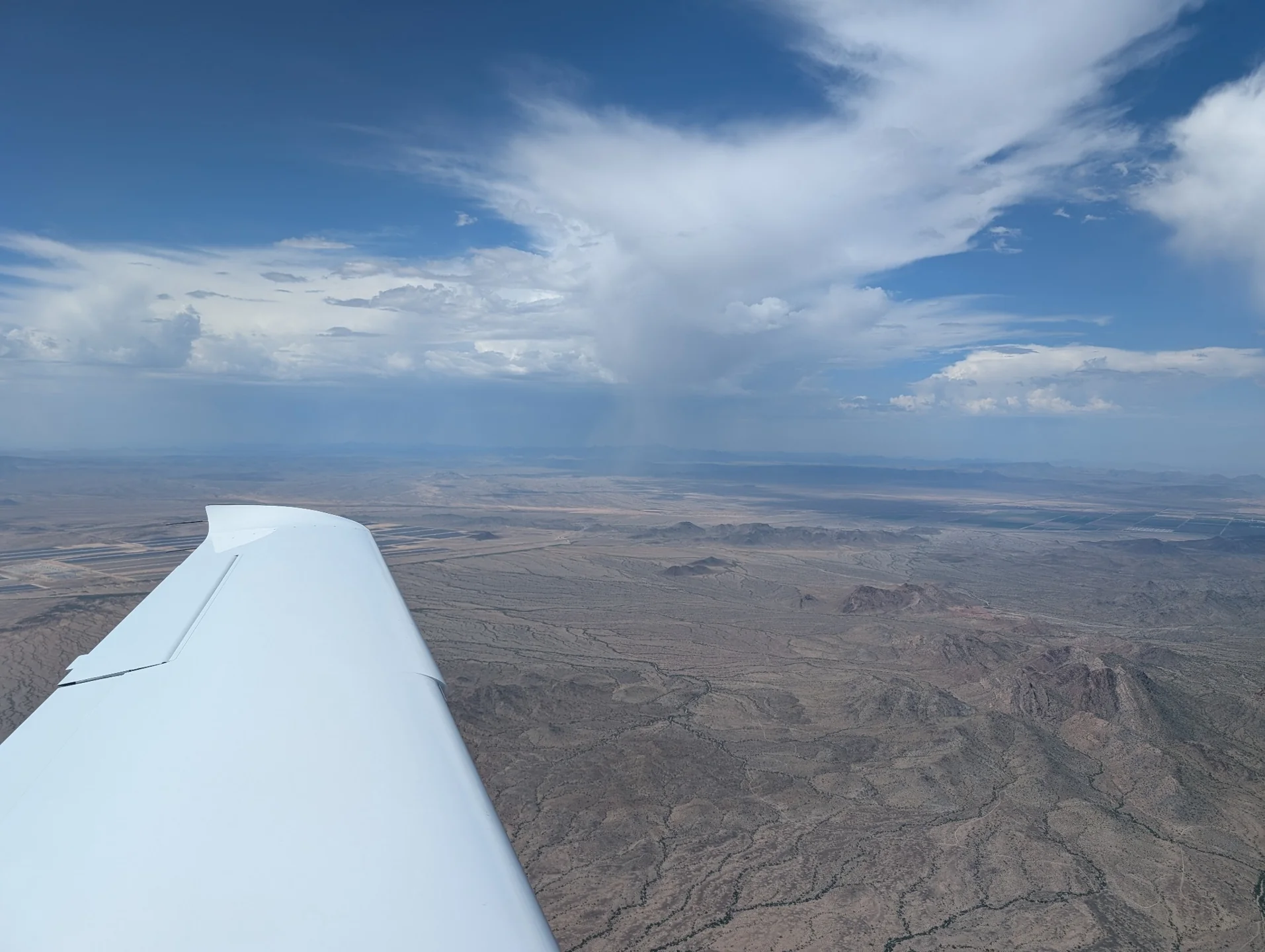 A rain cloud above the desert, seen from N721TP